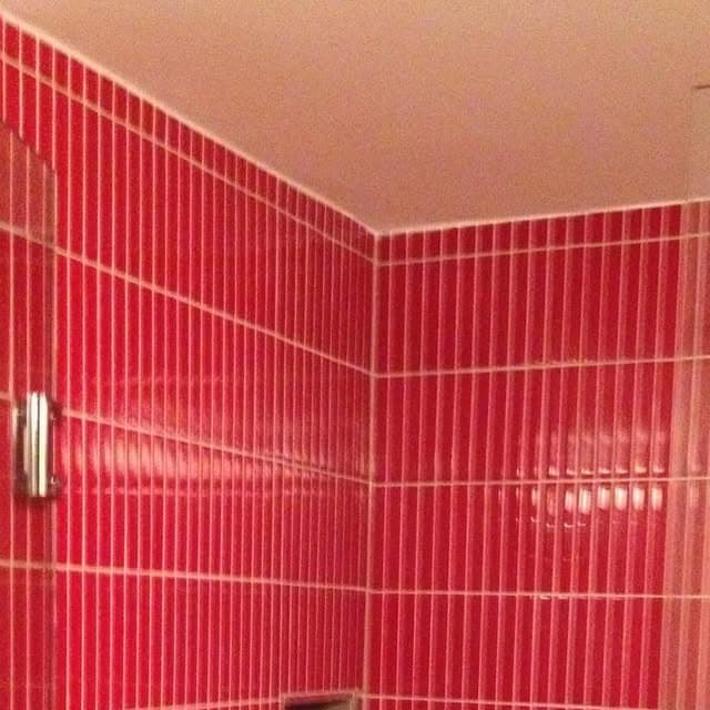 Crimson Stack Shower — Vertical glass stack-bond